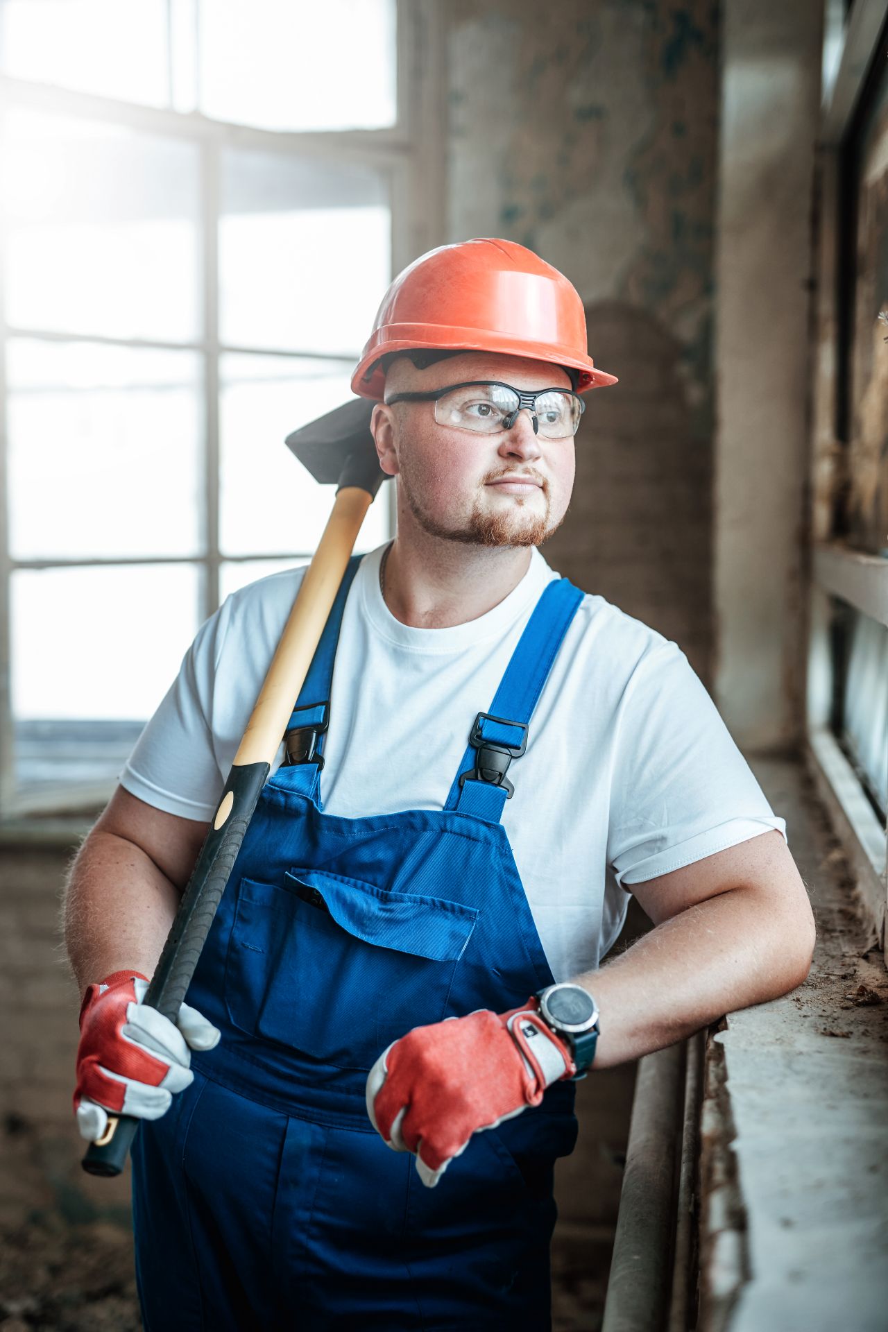 handsome-builder-stands-by-the-window-and-holds-a-2025-01-26-12-26-17-utc.jpg